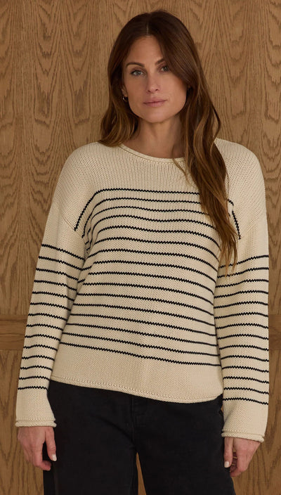 Woman wearing a cream and black striped sweater against a wooden background Jacques Sweater | Black Stripe | Rylee + Cru